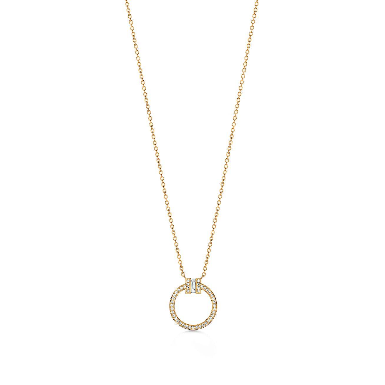 T*f*ny t diamond pendant in 18k gold with a baguette diamond